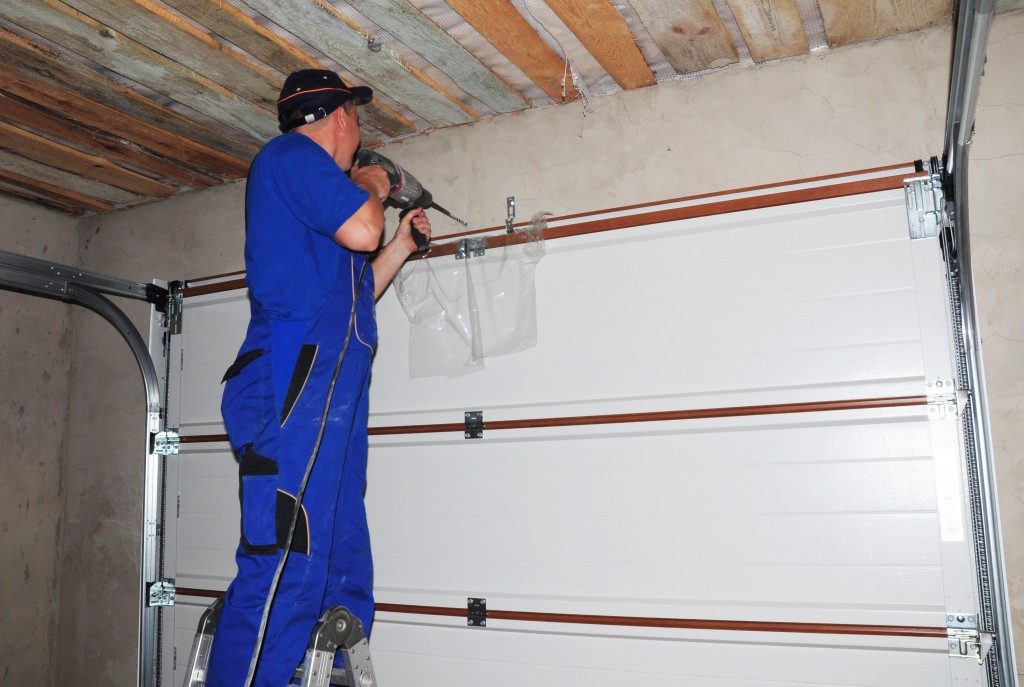 Contractor installing a garage door