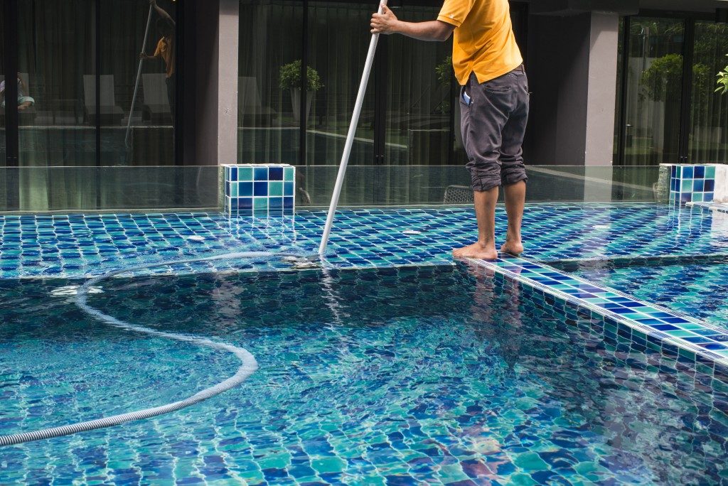 Man cleaning a swimming pool