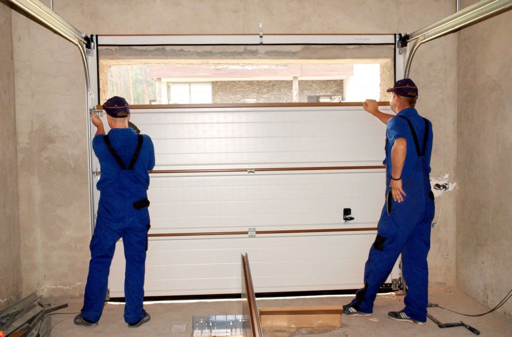 two men installing a garage door
