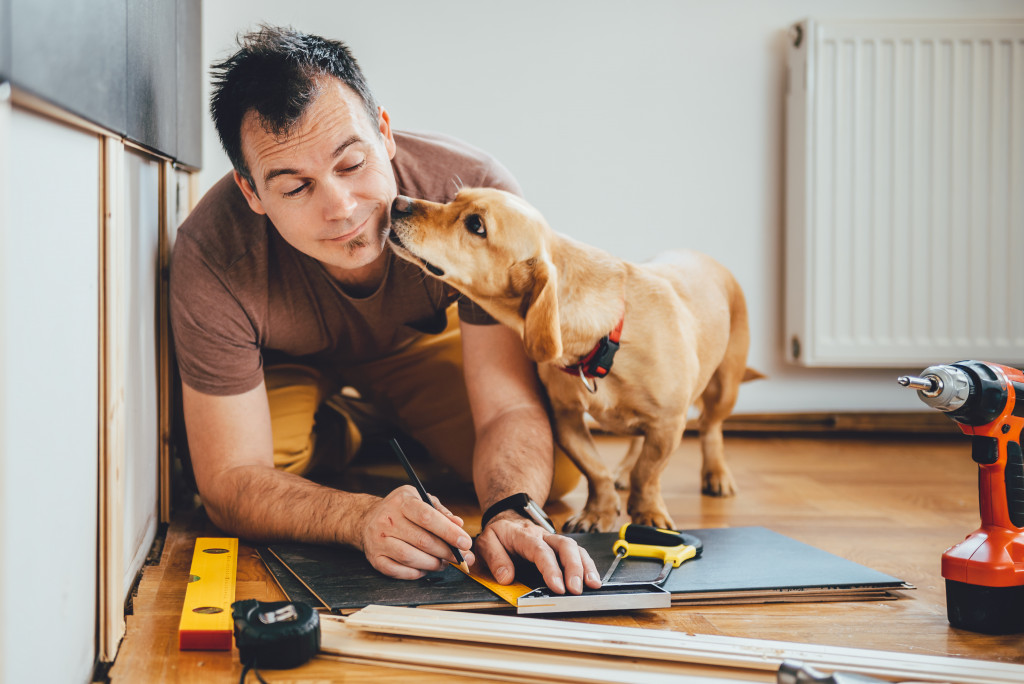 man renovating with dog