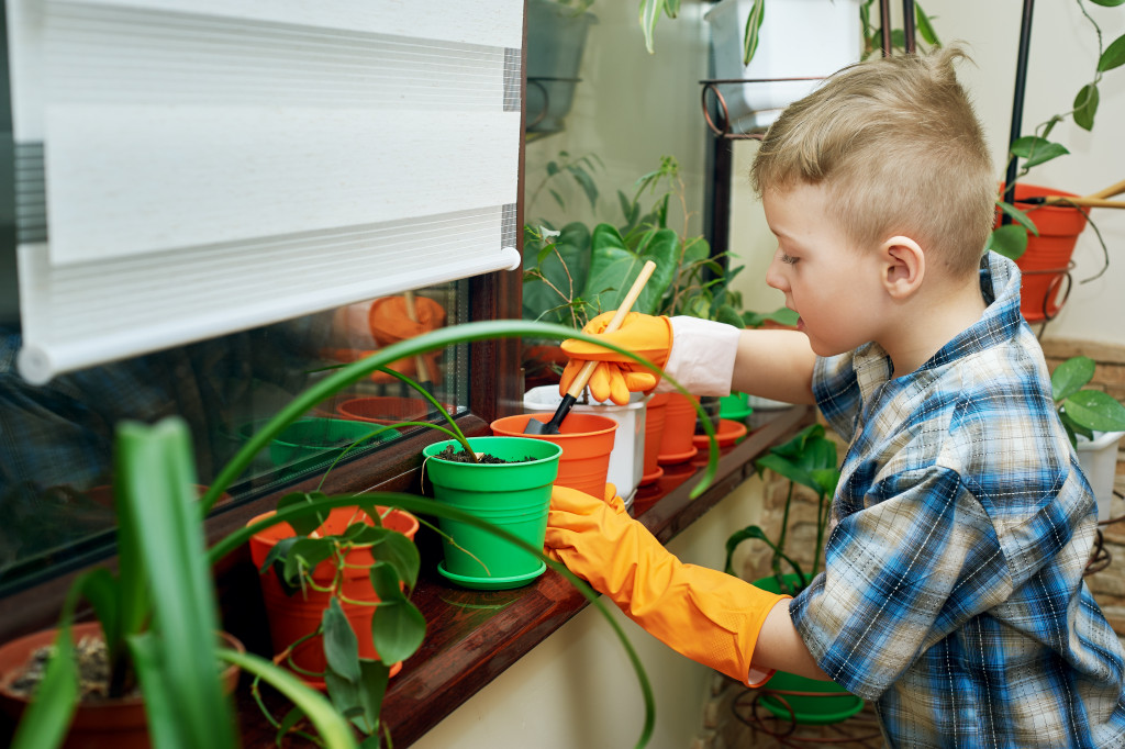 A young child planting at home