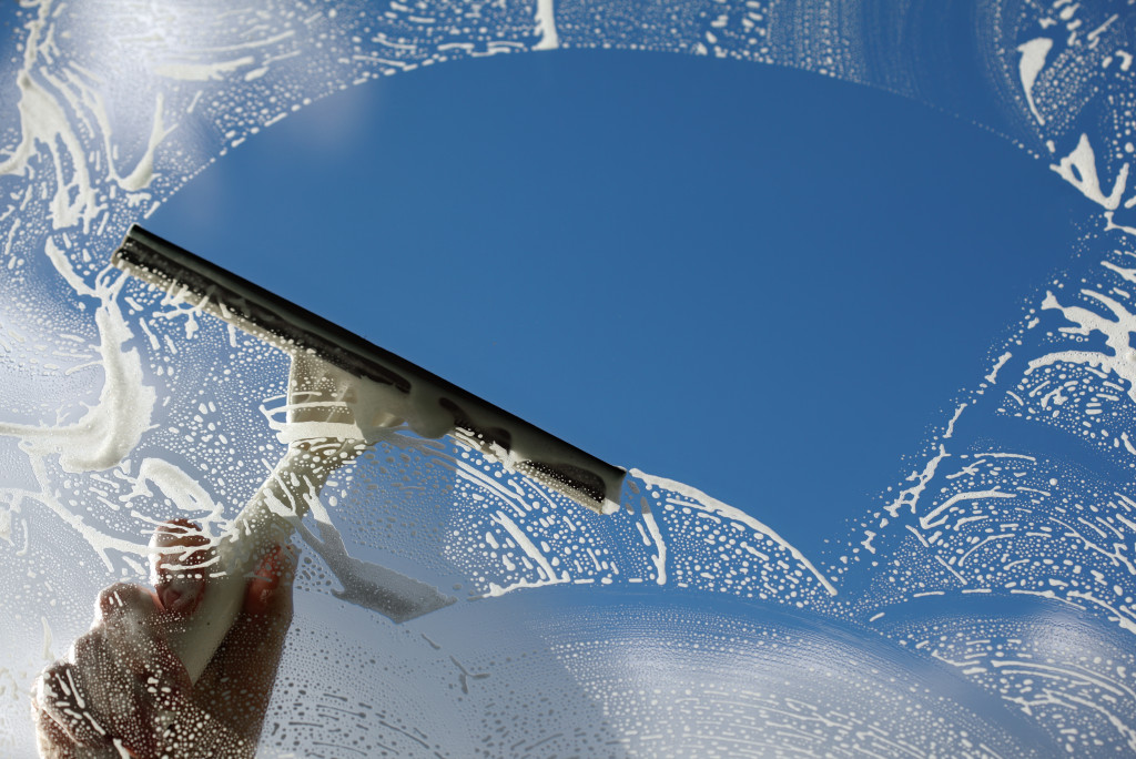 A window cleaner washing a window