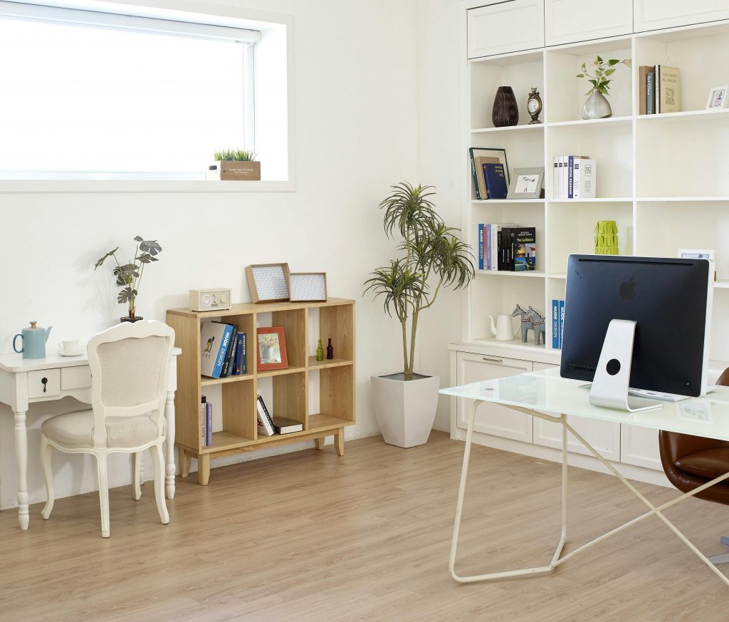 home office with a built-in bookshelf and a desk with a computer